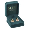 Open bottle green velvet jewellery box CHA2P-V holding a pair of drop earrings, gold MJB logo inside the lid